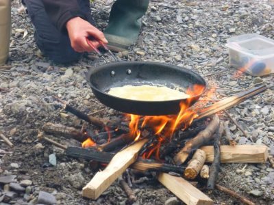 bushcraft firelighting course cooking pancakes outdoors at arete centre, North Wales